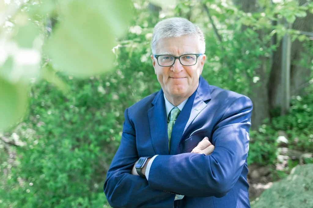 Harald Tomesch in blue suit in garden